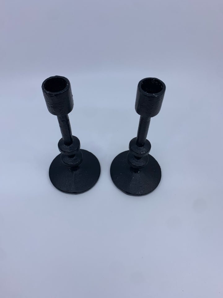 2 CAST IRON TAPER CANDLE HOLDERS.