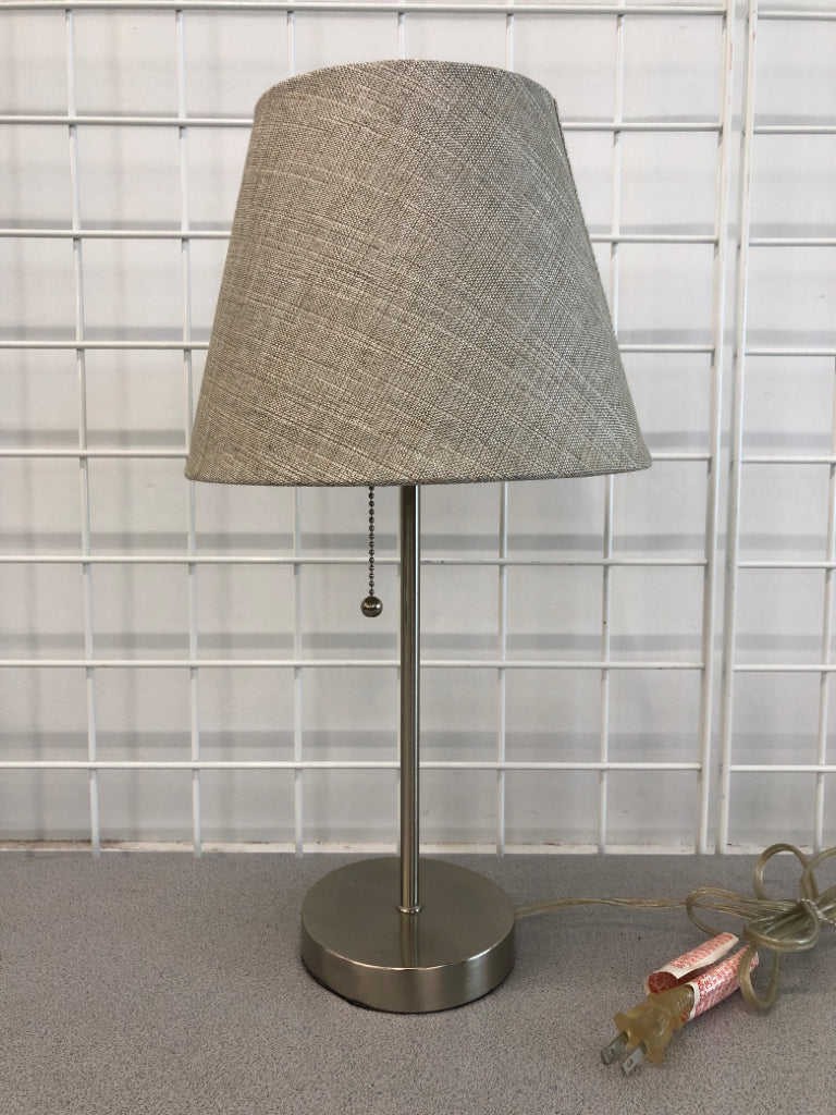 METAL LAMP W/GRAY FABRIC SHADE.