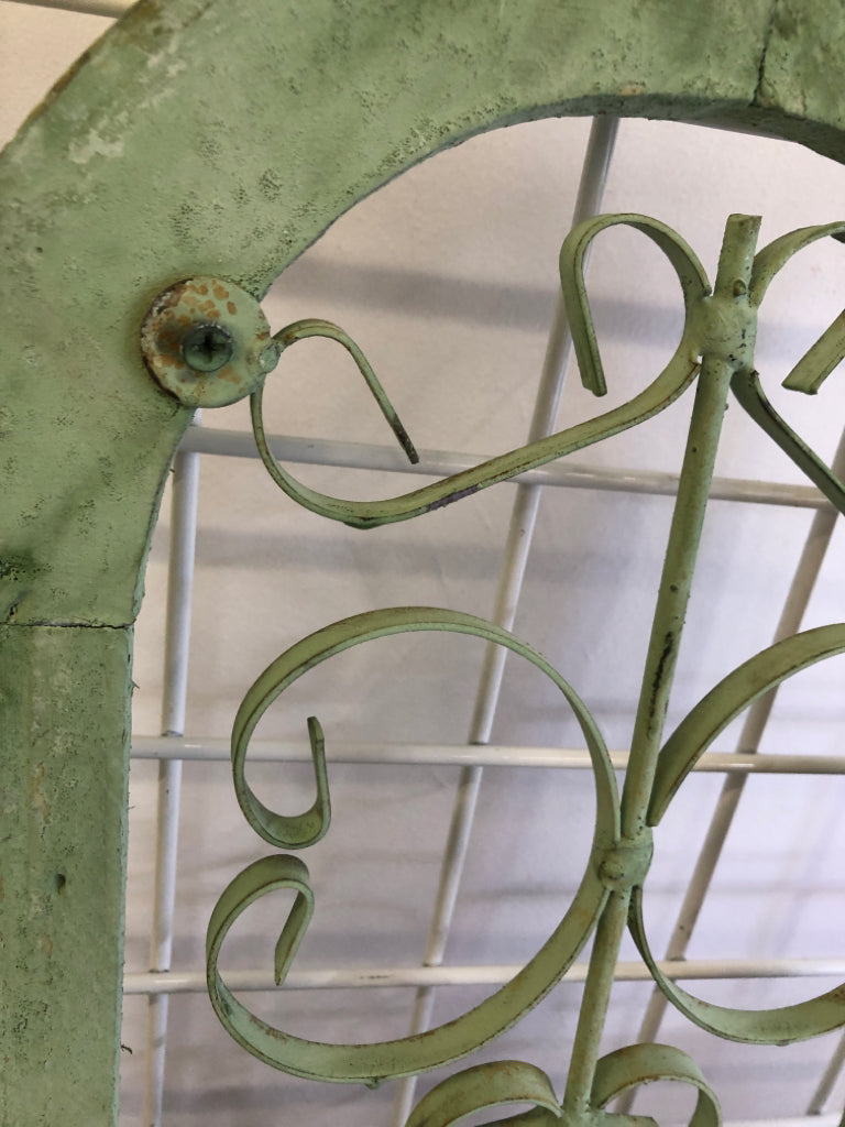 DISTRESSED GREEN PAINTED ARCH W/ METAL SCROLL WALL ART.