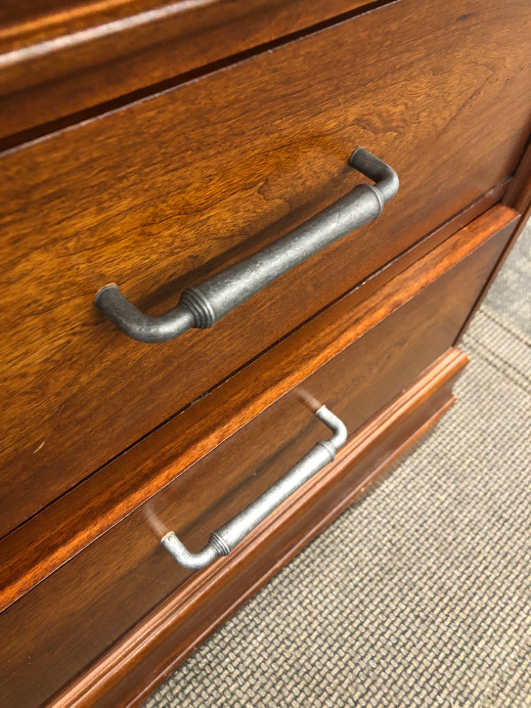 DARK CHERRY SIDE TABLE W/VTG METAL HANDLES & GLASS COVER ON WHEELS.