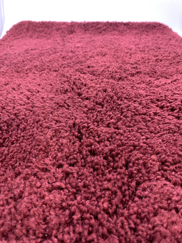 RED BATH MAT.