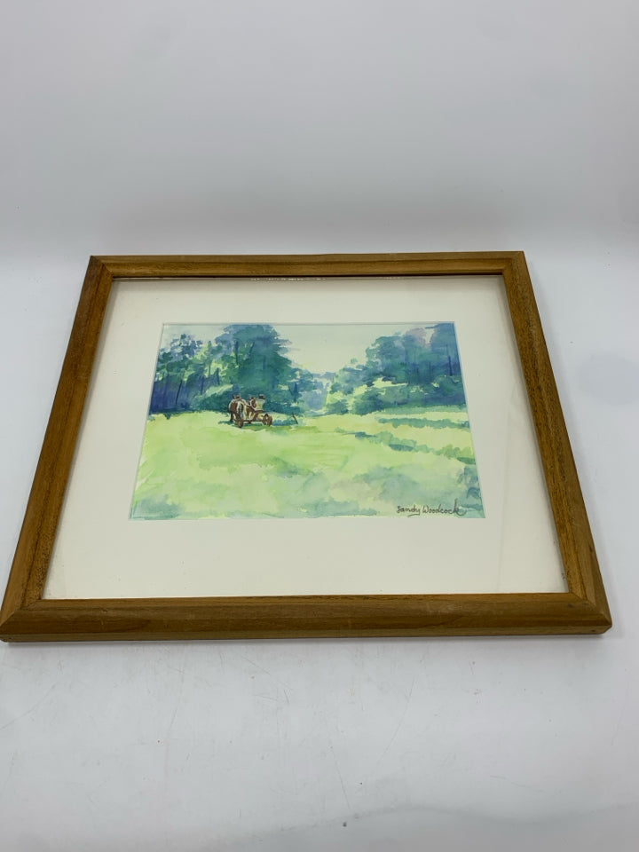 WATERCOLOR FIELD W/HORSE DRAWN CARRIAGE IN WOOD FRAME.