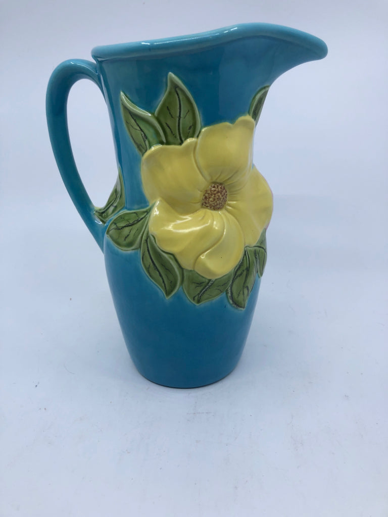 VTG BLUE POTTERY PITCHER W/ EMBOSSED PINK/YELLOW FLOWERS.