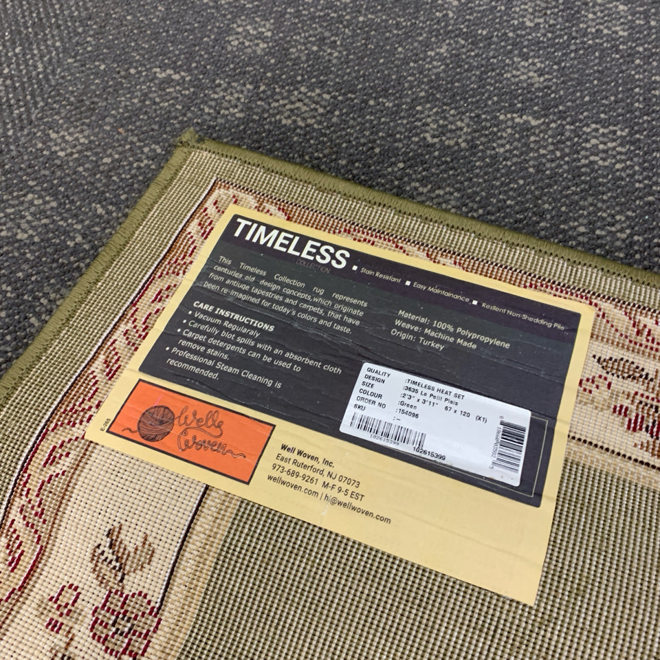 GREEN RUG W/FLORAL MEDALLION DESIGN.