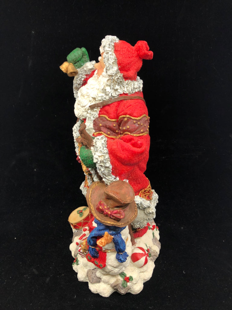 RESIN SANTA W TOYS AND SNOWMAN.