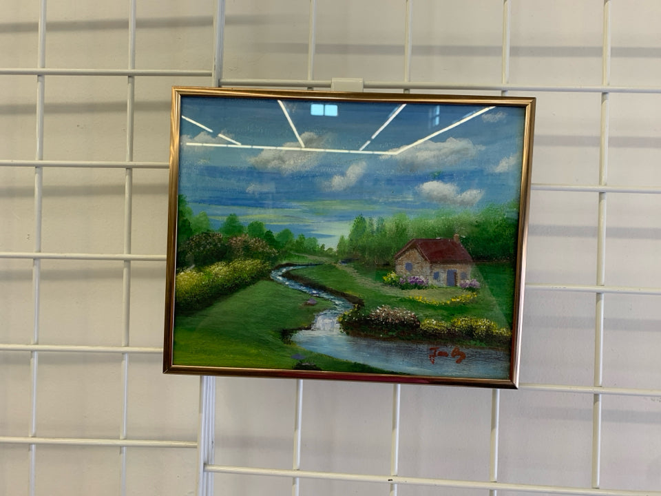SMALL PAINTED OF COTTAGE W/ SMALL RIVER BLUE SKIES.