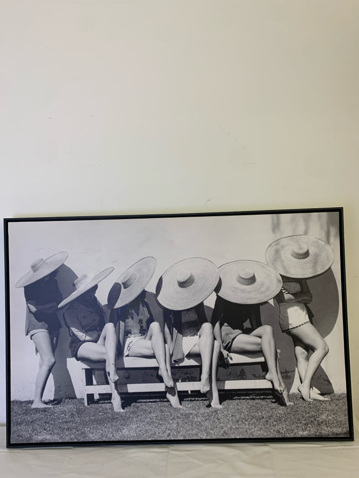 LADIES IN SUN HATS ON CHAIRS BLACK AND WHITE WALL HANGING.