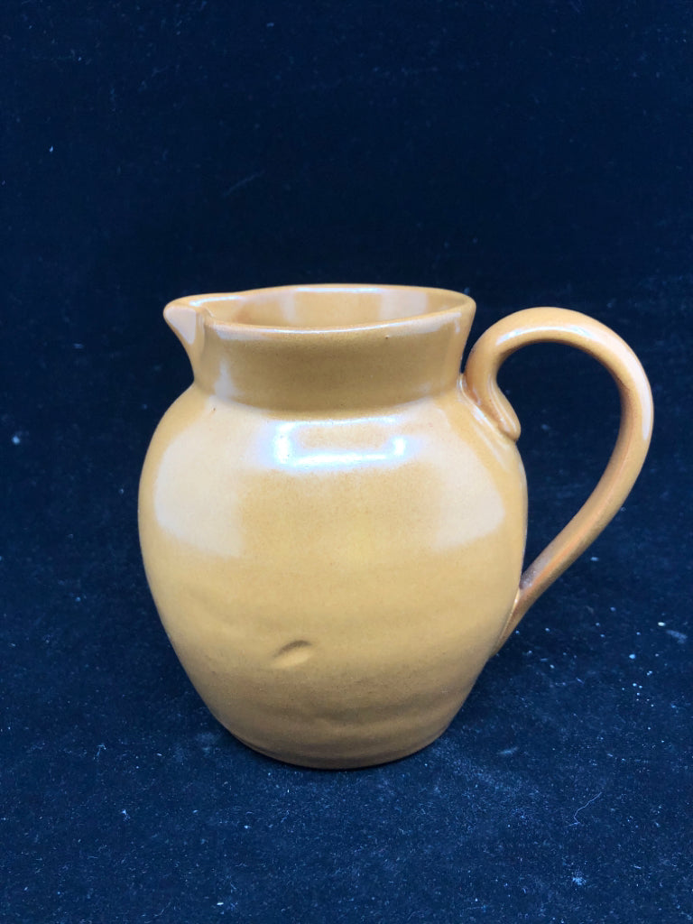 ORANGE POTTERY PITCHER.