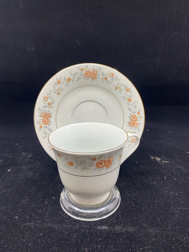 ORANGE AND BLUE FLORAL TEA CUP AND SAUCER.