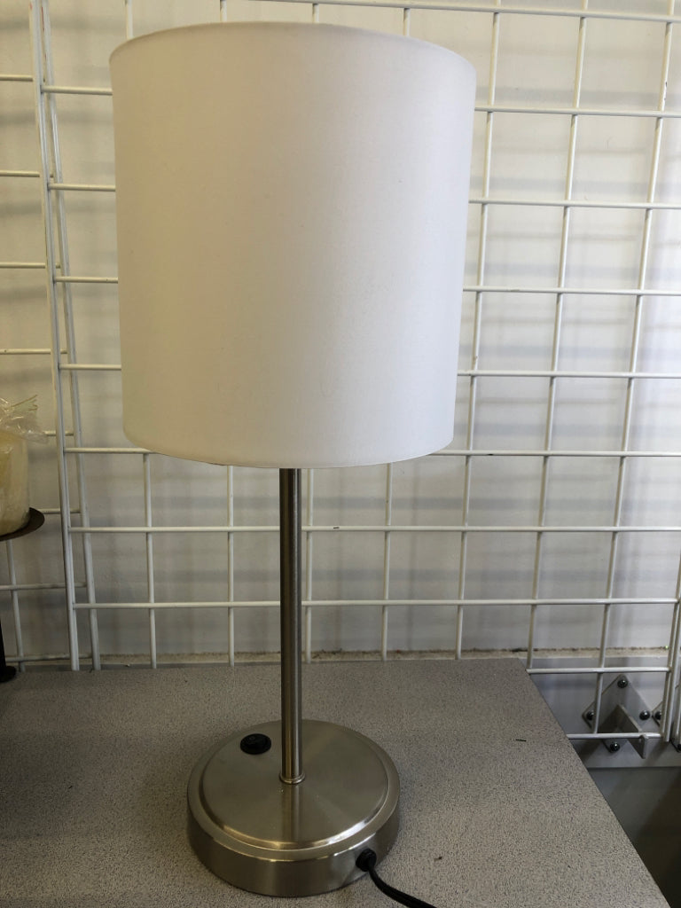 SKINNY SILVER METAL BASE LAMP W/ WHITE SHADE.