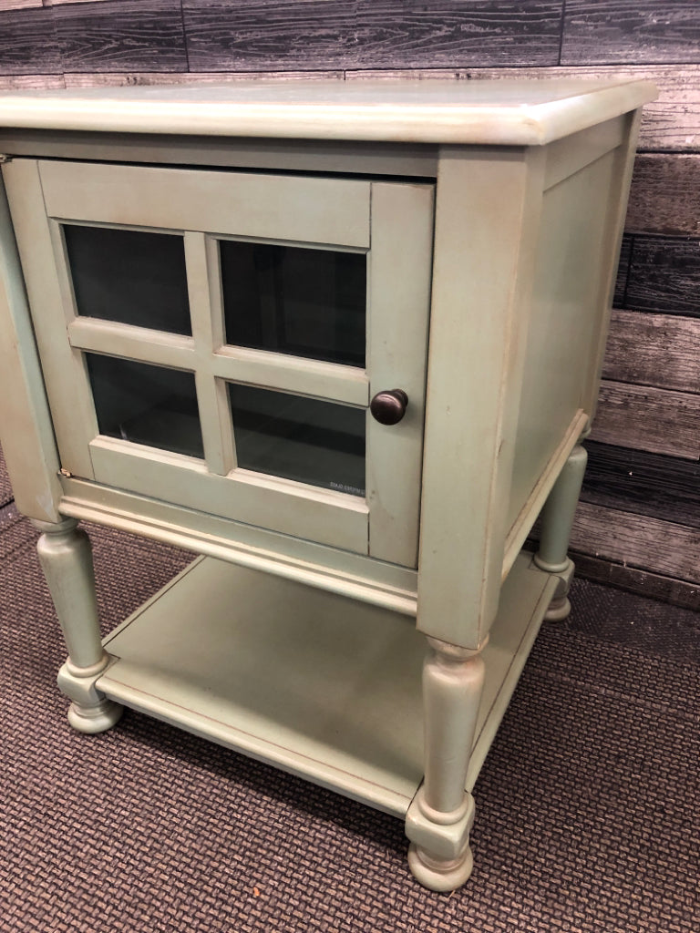 SMALL GREEN END TABLE W CABINET AND BOTTOM SHELF.