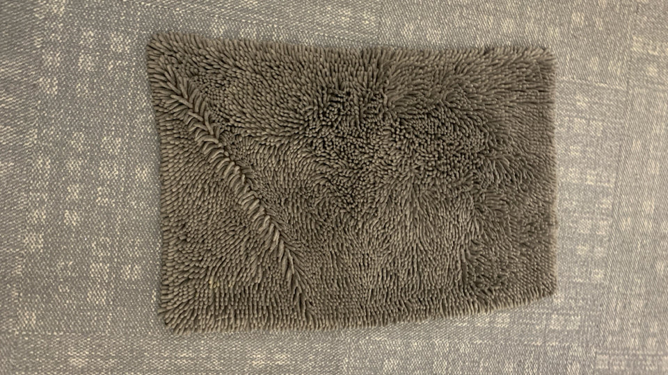BROWN SHAG BATHROOM RUG.