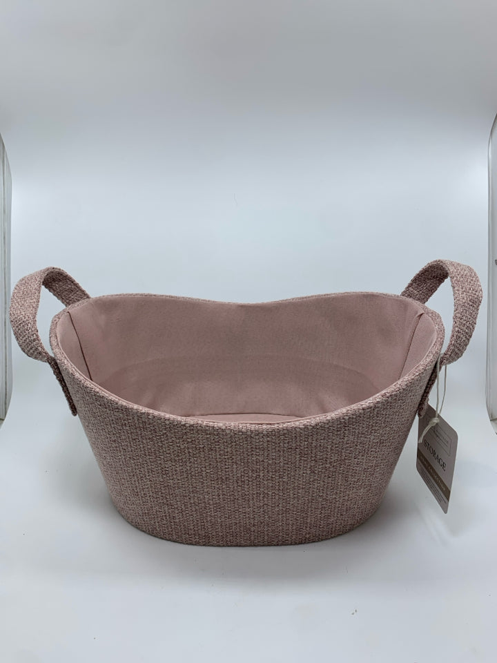 PINK FABRIC OVAL STORAGE BIN W/HANDLES.