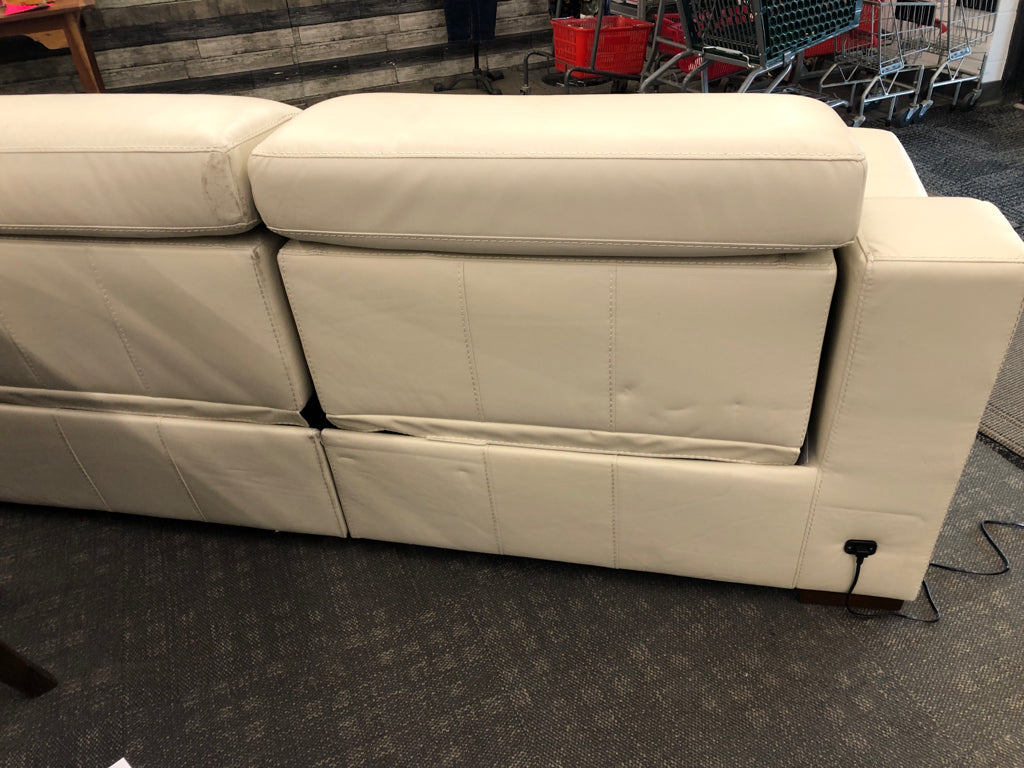 WHITE FAUX LEATHER RECLINING LOVE SEAT.