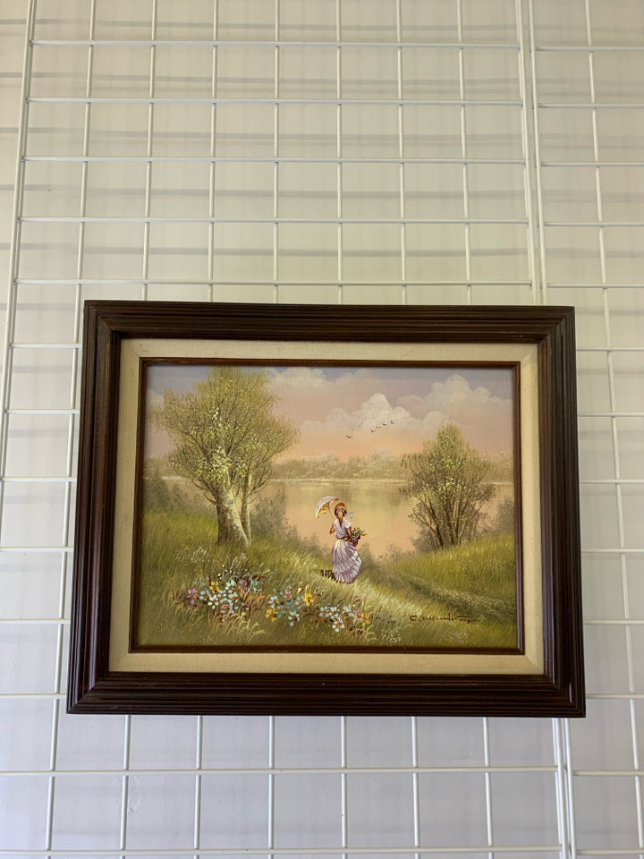 LITTLE GIRL SITTING AT LAKE W UMBRELLA PATTERN IN BROWN FRAME.