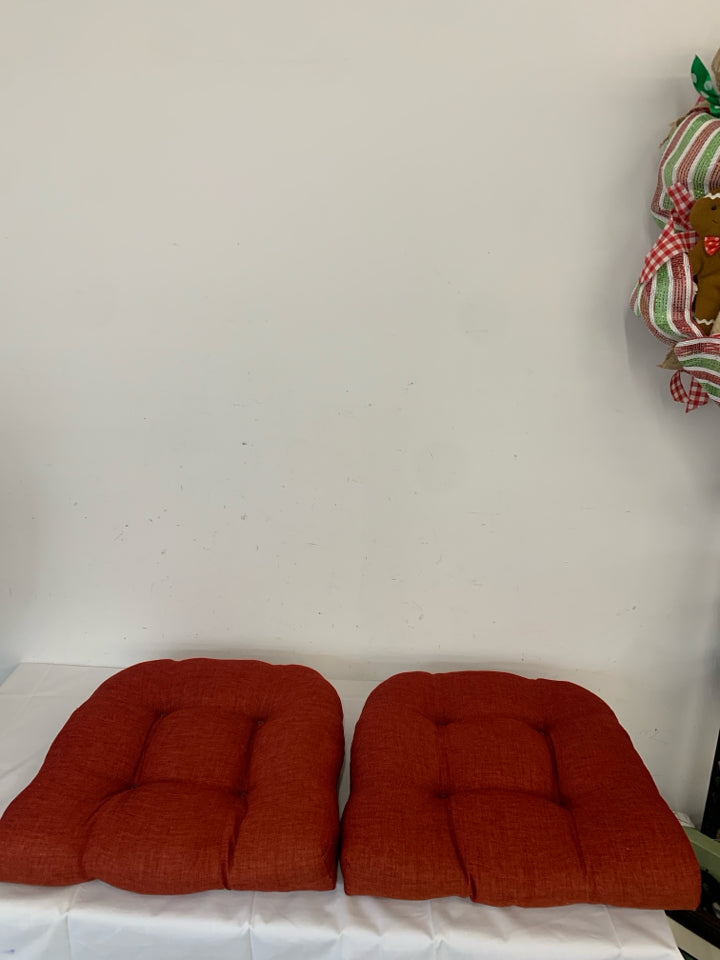 2 RED CHAIR CUSHIONS.