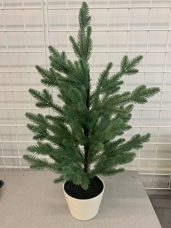 FAUX SPRUCE TREE IN WHITE POT.