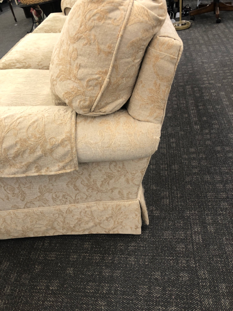 CREAM VELVET SOFA W/ EMBOSSED SCROLL DESIGN.