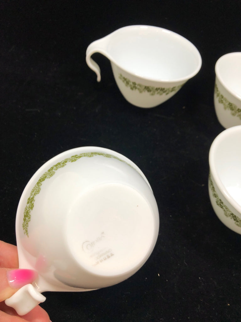 4 CORELLE GREEN FLOWER COFFEE MUGS.