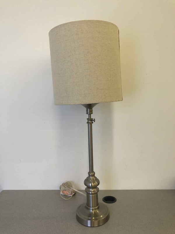 SILVER SKINNY BASE LAMP W/ TEXTURED CREAM SHADE.