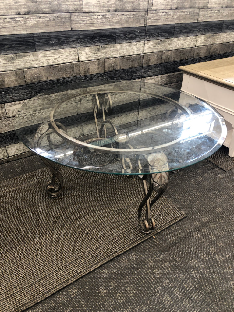 GLASS CIRCLE COFFEE TABLE W/ DISTRESSED SLIVER BASE/LEGS.