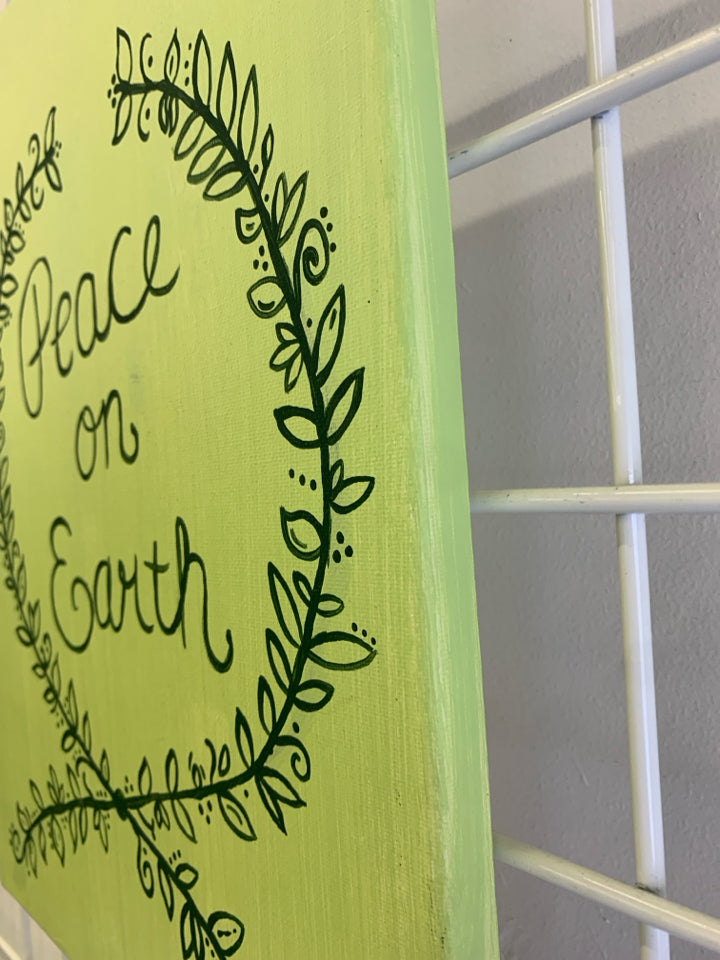 GREEN CANVAS PEACE ON EARTH WALL DECOR.