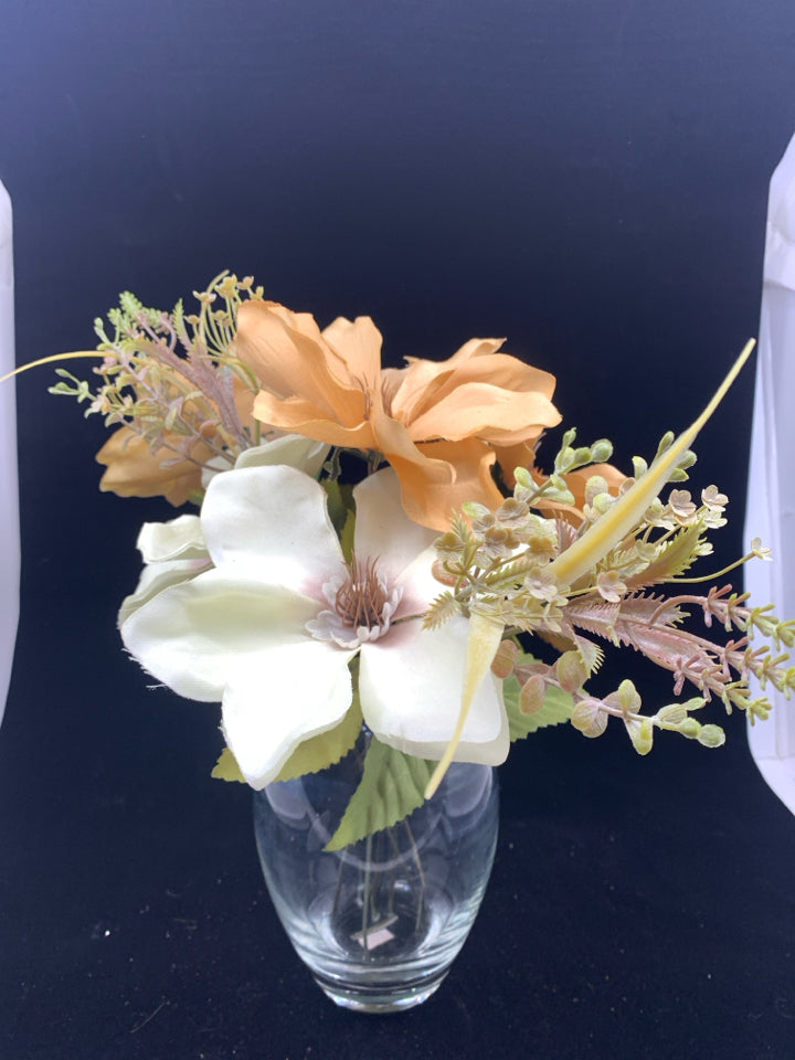 ORANGE AND CREAM FLORAL IN CLEAR VASE W FAUX WATER.