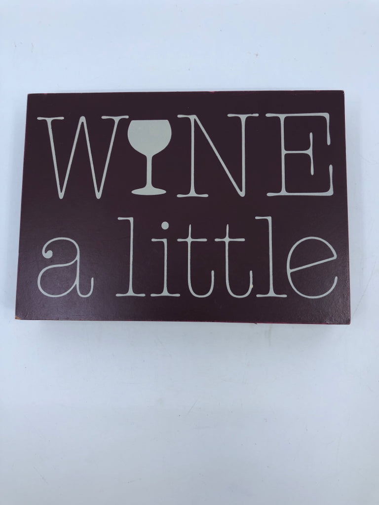 WINE A LITTLE BLOCK SIGN.