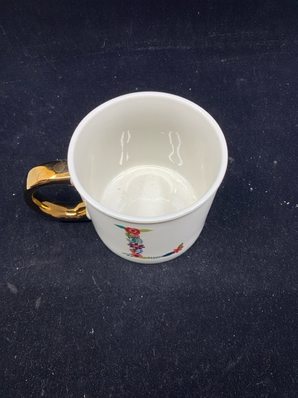 WHITE MUG W/ FLORAL "L" GOLD HANDLE.