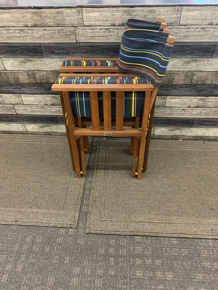 2 FOLD UP DIRECTOR CHAIRS DARK BROWN W/ COLORFUL STRIPE PATTERN.