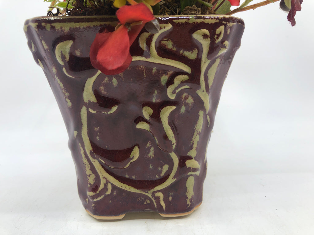 DISTRESSED RED PLANTER W/ FAUX RED FLOWERS.