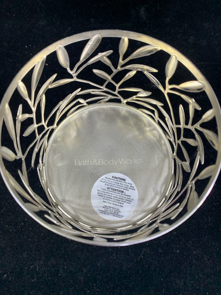 FOOTED SILVER METAL CANDLE SLEEVE LEAF DETAIL.