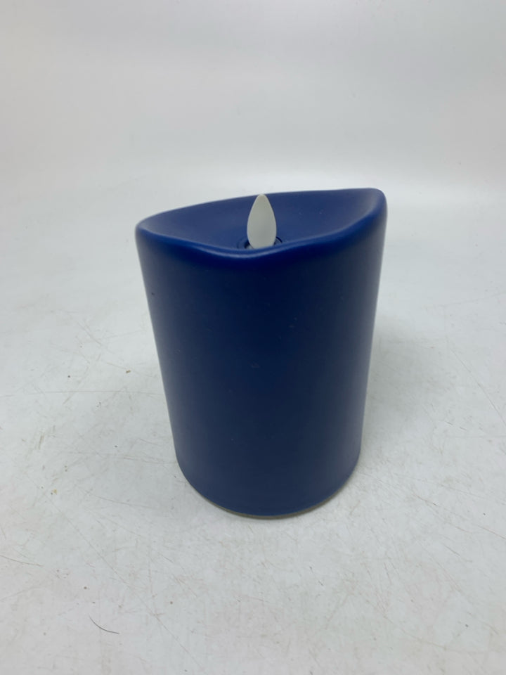 PLASTIC LARGE PILLAR CANDLE W/ BATTERY POWERED LIGHT.