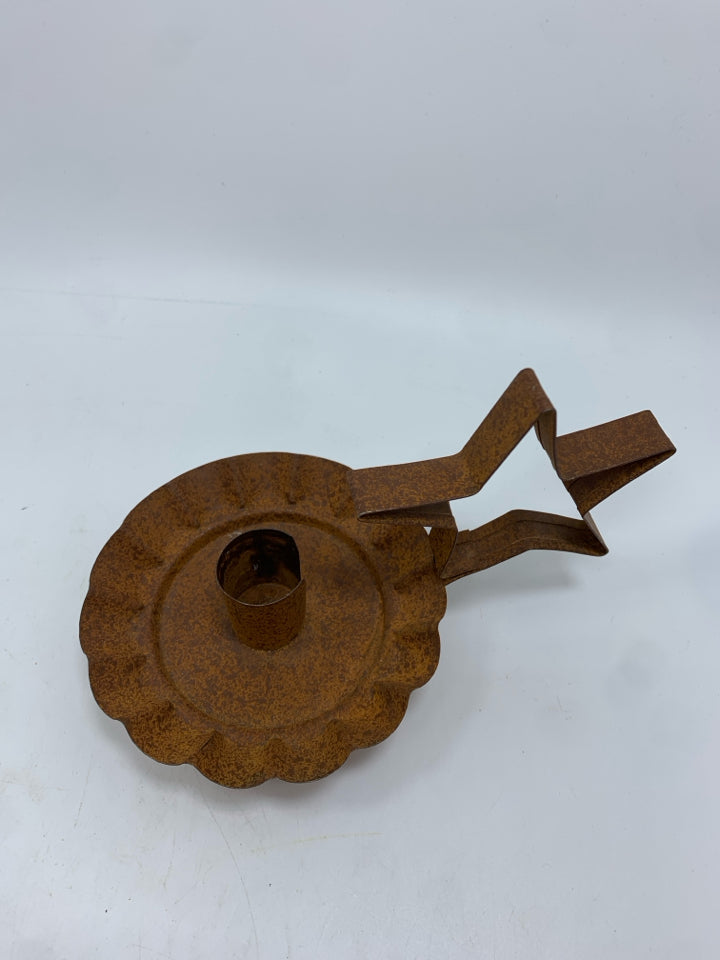 PRIMITIVE BROWN METAL STAR CANDLESTICK HOLDER.