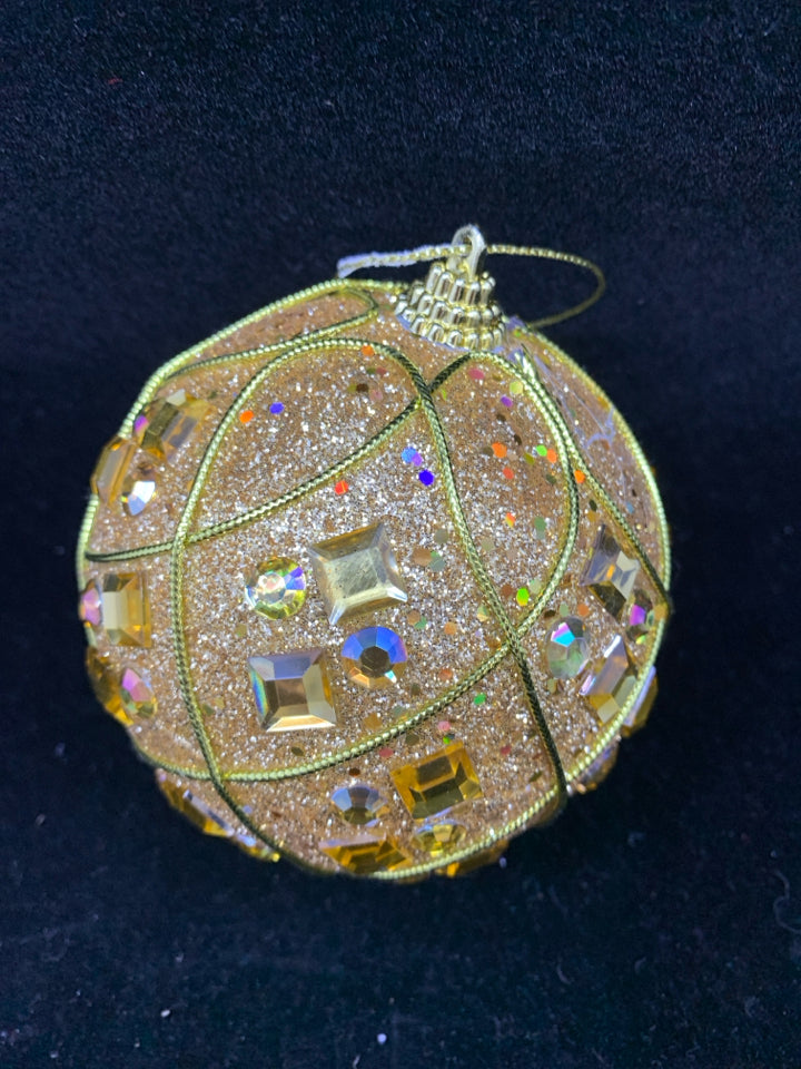 GOLD GLITTER PLASTIC ORNAMENT.
