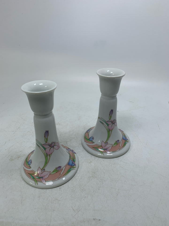 2 FOOTED FLORAL PORCELAIN TAPERED CANDLE HOLDERS.