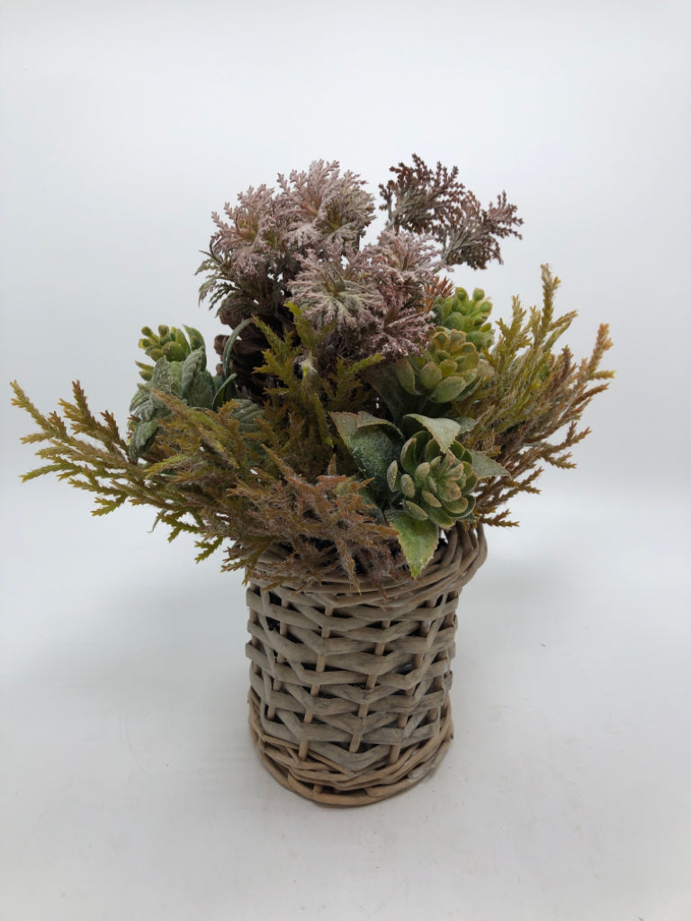 SM FAUX GREENERY ARRANGEMENT W/PINECONES IN WICKER VASE.