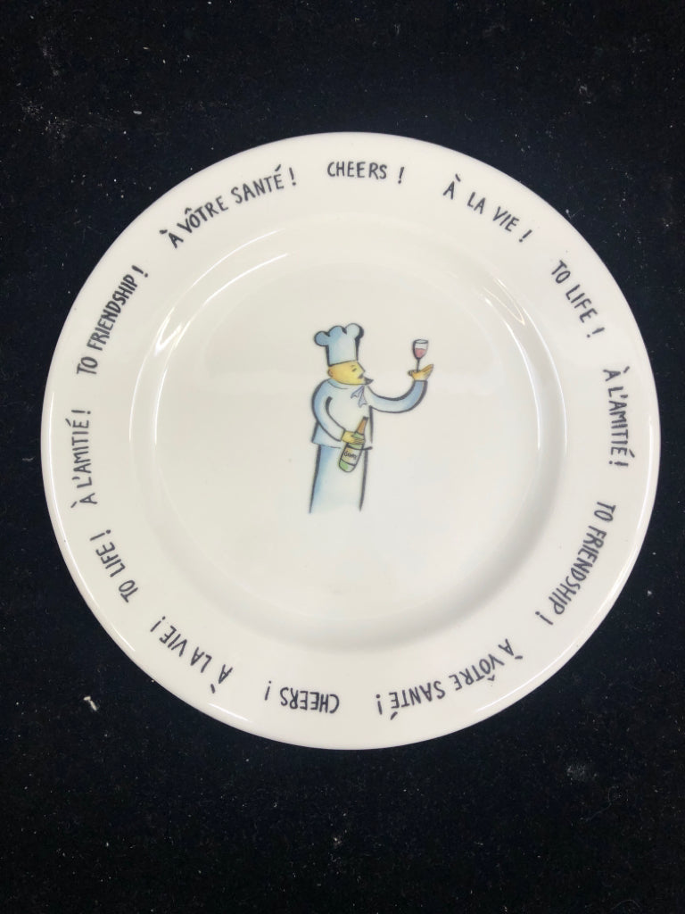 CHEERS W CHEF HOLDING WINE PLATE.