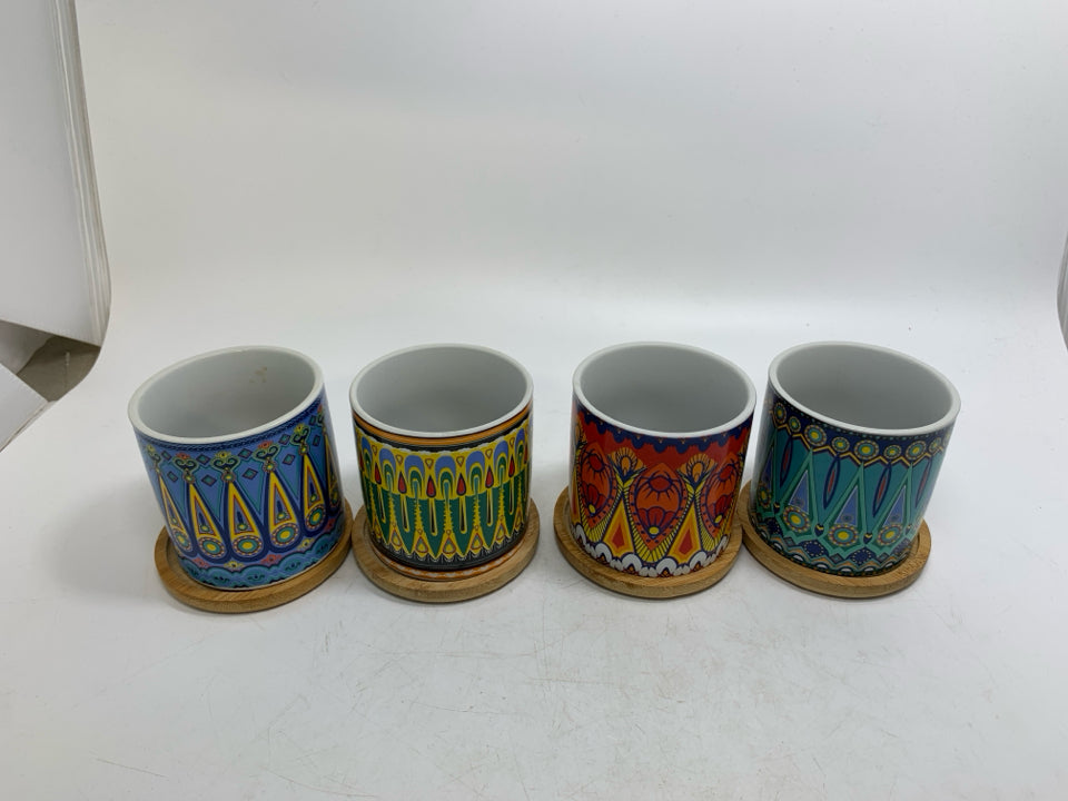 4 SMALL ASSORTED COLORFUL PLANTERS W/ WOOD DRIP PLATES.