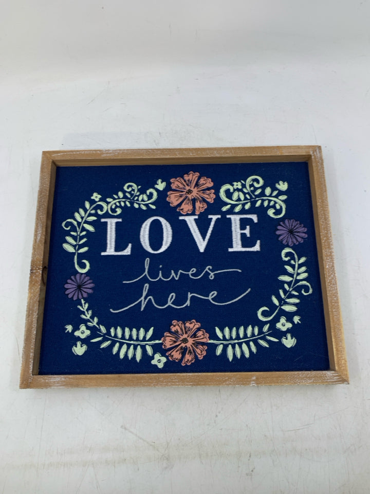 EMBROIDERED LOVE LIVES HERE NAVY BLUE BACKGROUND W/ FLOWERS.