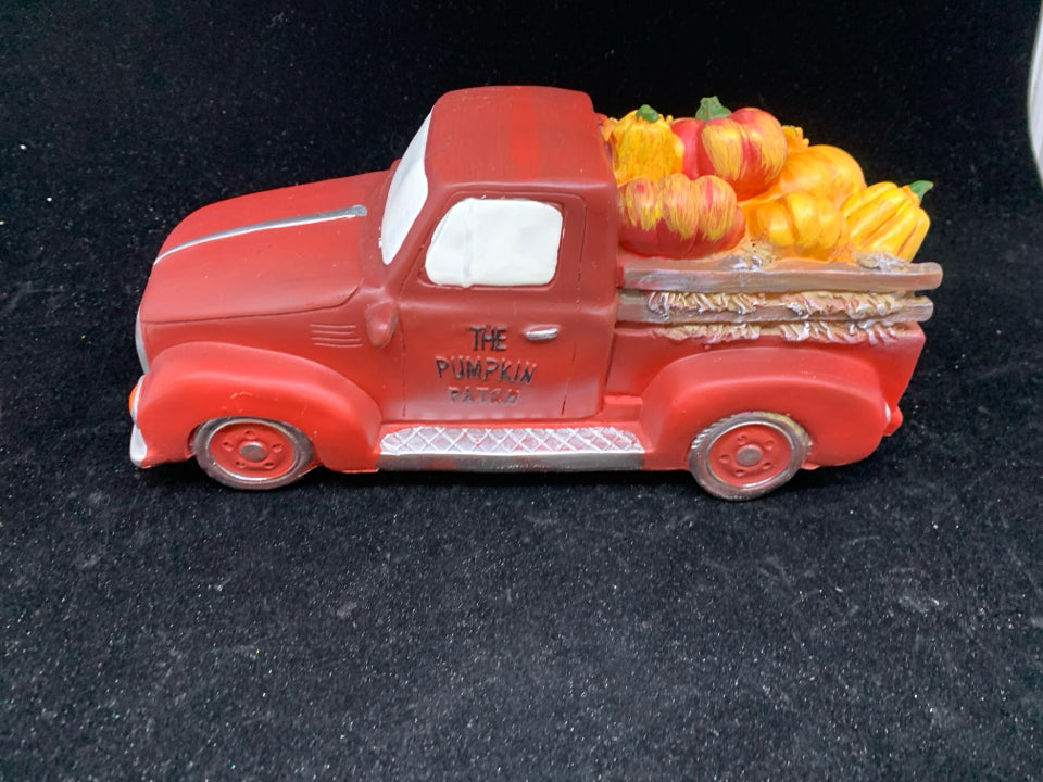 RED TRUCK WITH SUNFLOWERS AND PUMPKINS.