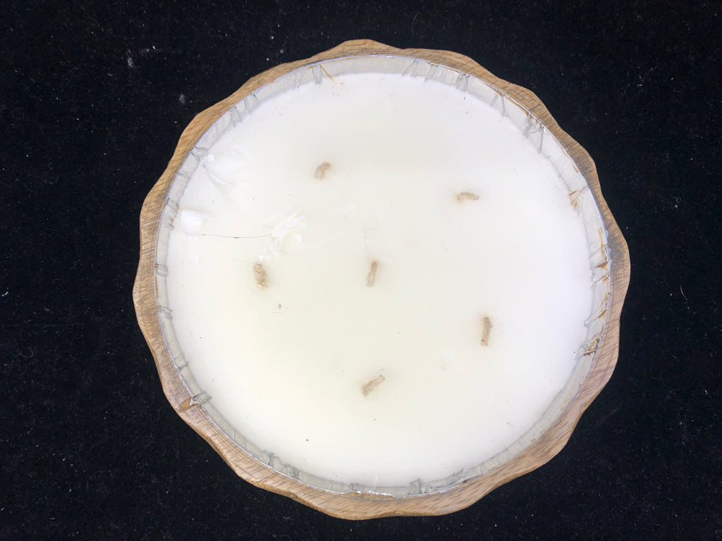 LARGE CANDLE IN ROUND WOOD BOWL.