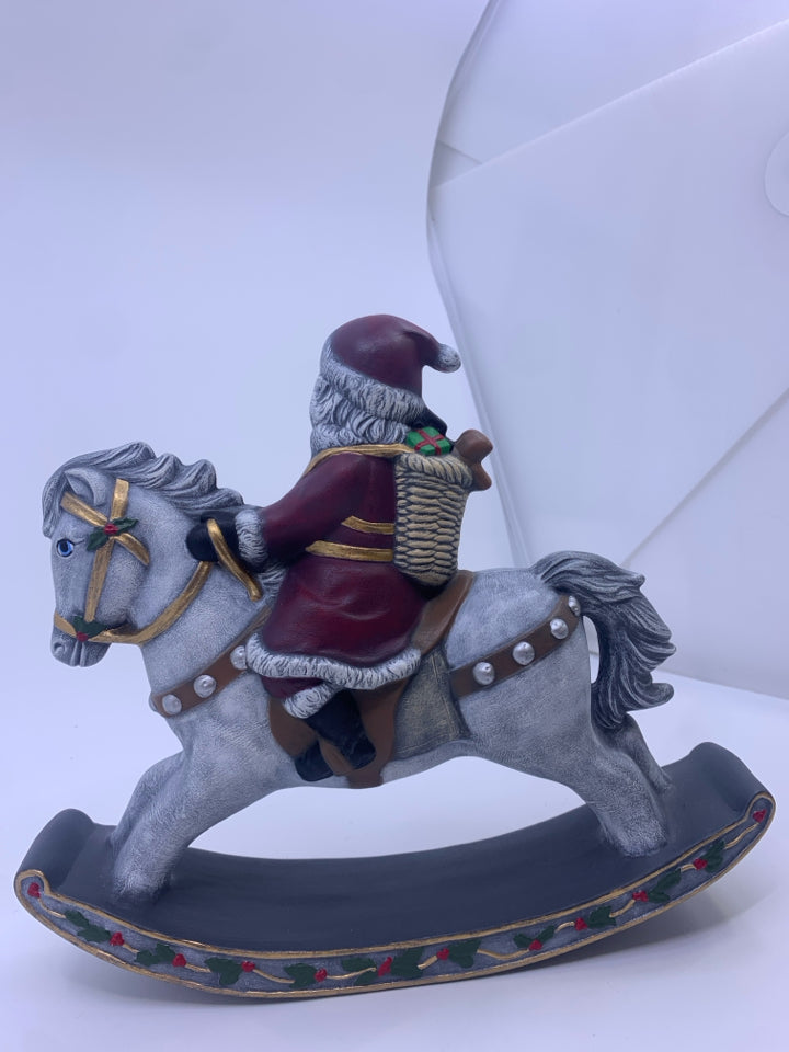 SANTA ON GRAY ROCKING HORSE.