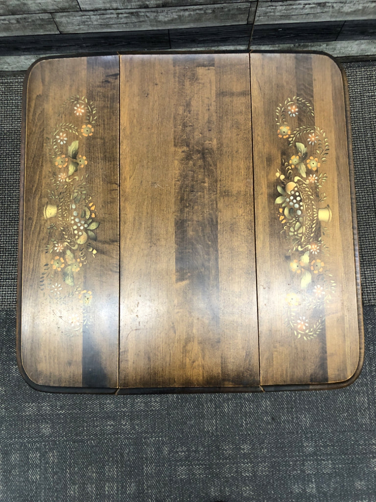 VTG DARK WOOD DROP LEAF SIDE TABLE W/ PAINTED BASKET OF FRUIT.