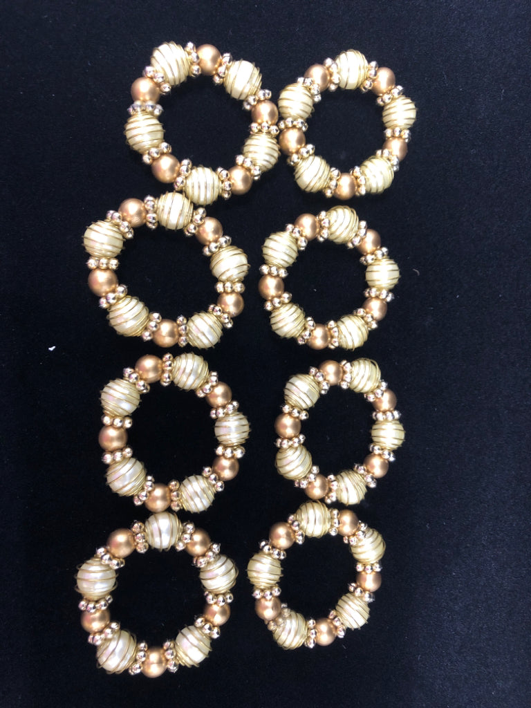 8 GOLD BEADED NAPKIN RINGS.