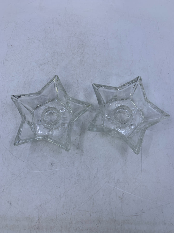 2 CLEAR GLASS STAR SHAPED TAPERED CANDLE HOLDERS.