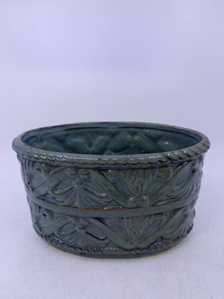 OVAL FADED TEAL PLANTER W/ EMBOSSED SCROLL DETAIL.