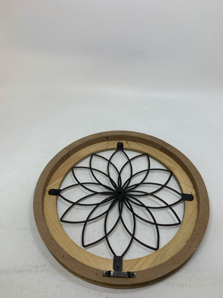 CIRCLE FRAME W/ METAL FLOWER IN CENTER.