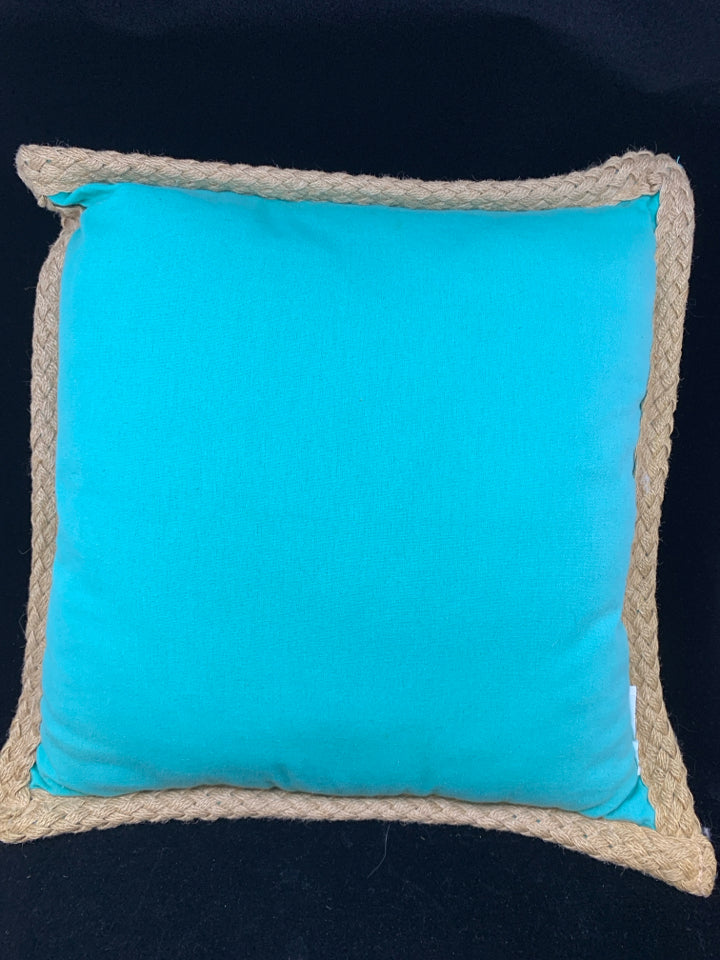 TEAL PILLOW W/WHITE DESIGN & BRAIDED BURLAP BORDER.
