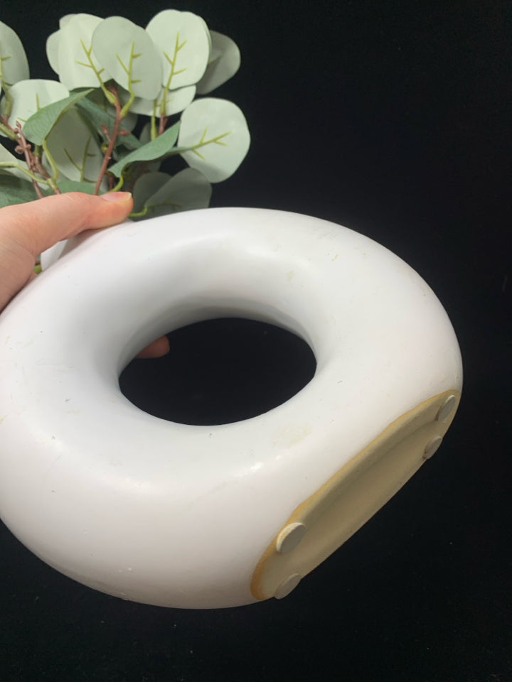 FAUX EUCALYPTUS IN ABSTRACT VASE.